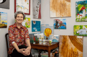 Close-up of a tactile painting by Nancy Land McCurtin, showcasing the thick sand textures and raised string used to create art beyond sight.